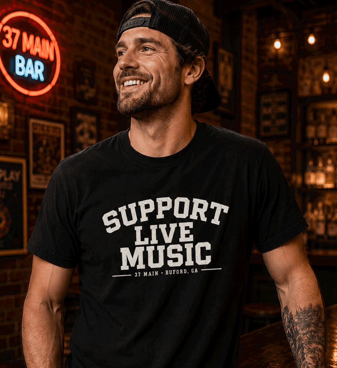 Man wearing a black Support Live Music 37 Main graphic T-shirt at 37 Main in historic downtown Buford, Georgia.